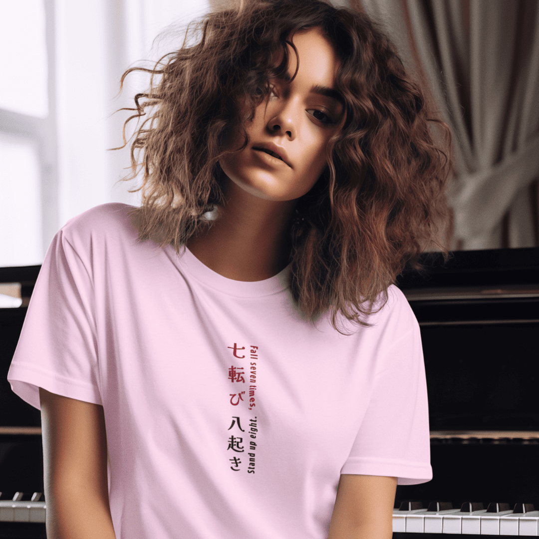Person wearing a pink t-shirt with text in a foreign language, sitting in front of a piano. wordsarmor