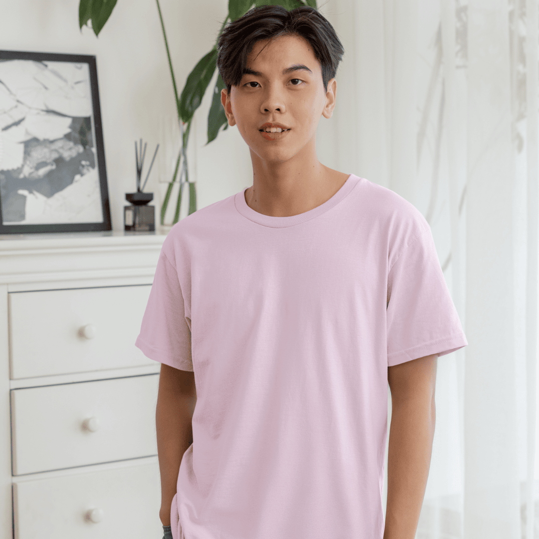 Male model wearing light pink oversized tshirt – minimal solid tshirt for men and women by Words Armor