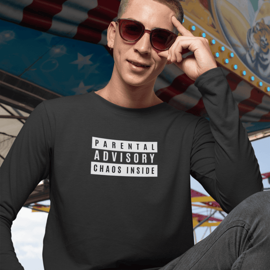 Person wearing a black sweatshirt with 'Parental Advisory Chaos Inside' text in front of a colorful background. wordsarmor