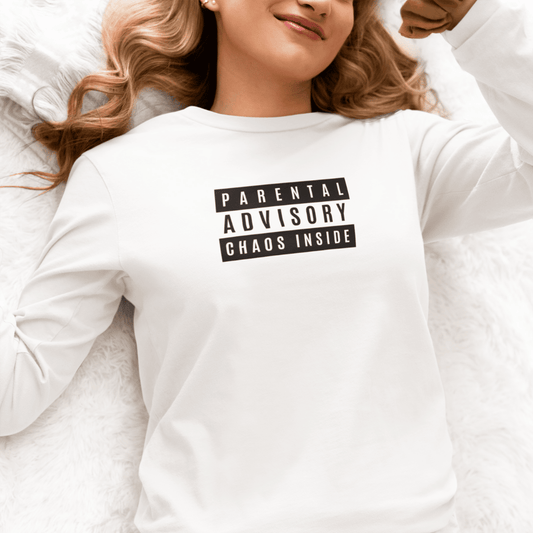 Person wearing a white sweatshirt with 'Parental Advisory Chaos Inside' text. wordsarmor