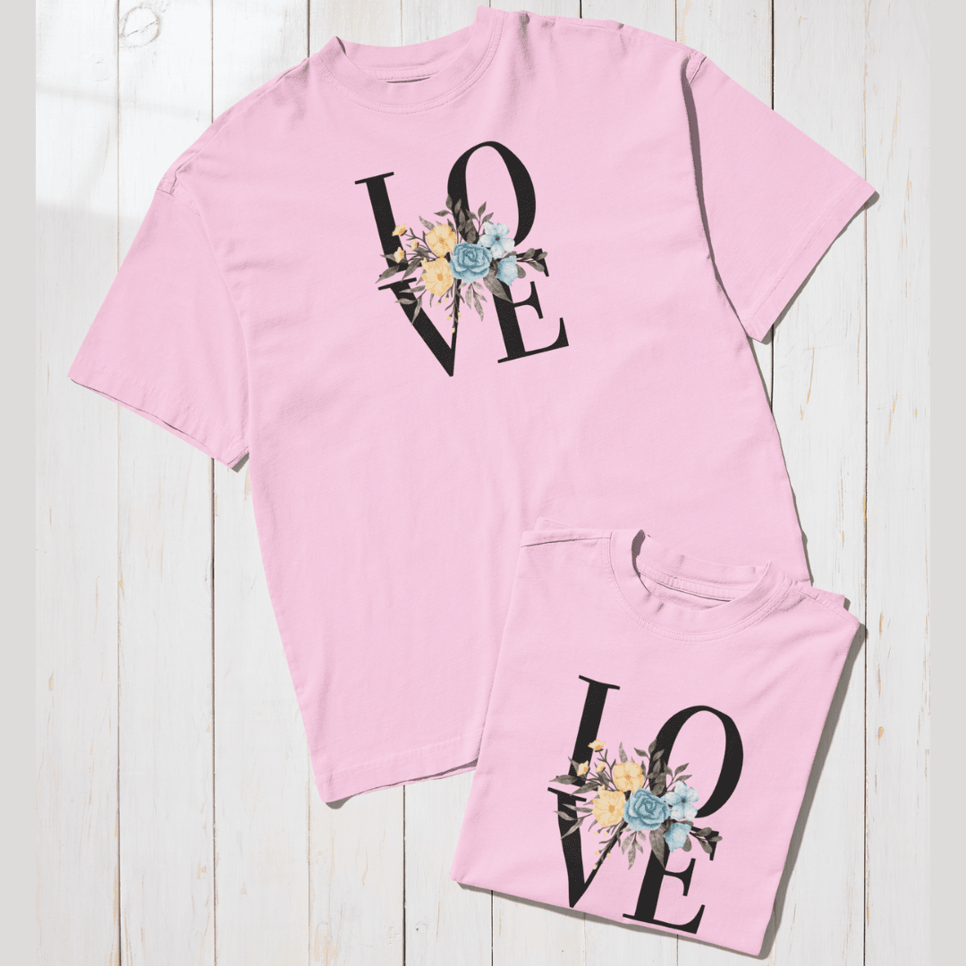 Baby pink t-shirt and shorts set with 'LOVE' design on a wooden surface wordsarmor