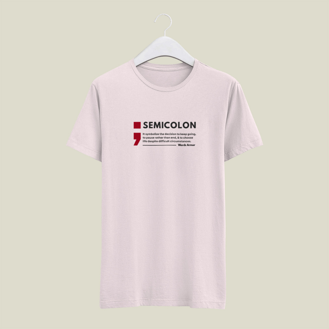 Baby Pink t-shirt with 'SEMICOLON' design on a hanger against a light green background wordsarmor