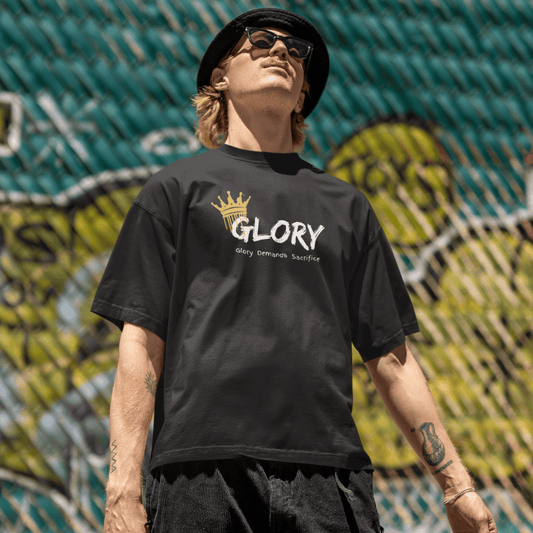 Person wearing a black t-shirt with 'GLORY' printed on it, standing in front of a colorful mural. wordsarmor
