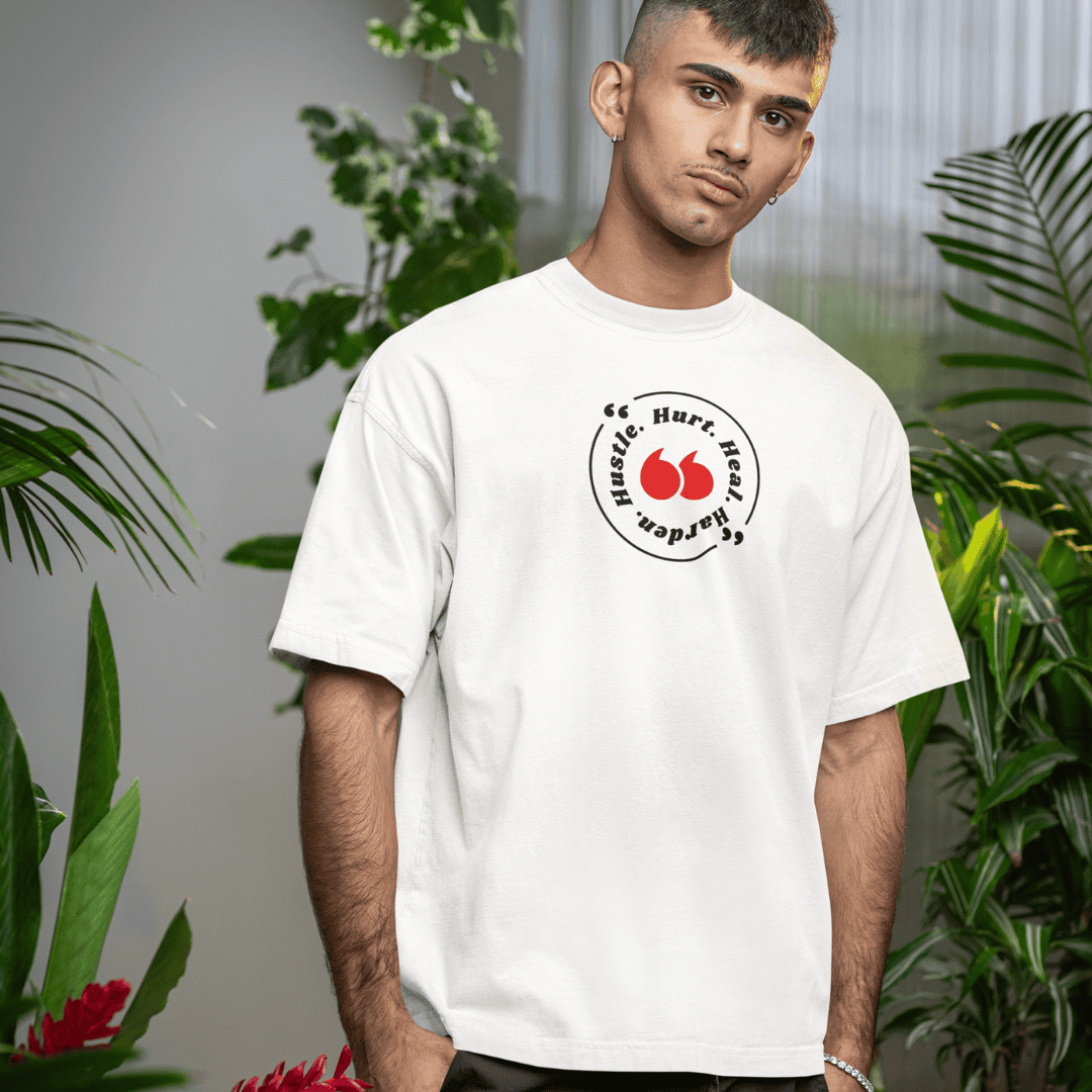 Person wearing a white t-shirt with a logo in a room with plants wordsarmor