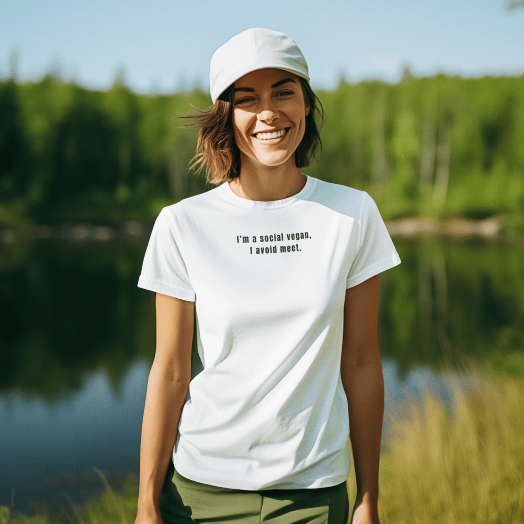 Woman wearing a white t-shirt with text standing by a lake with greenery in the background wordsarmor.
