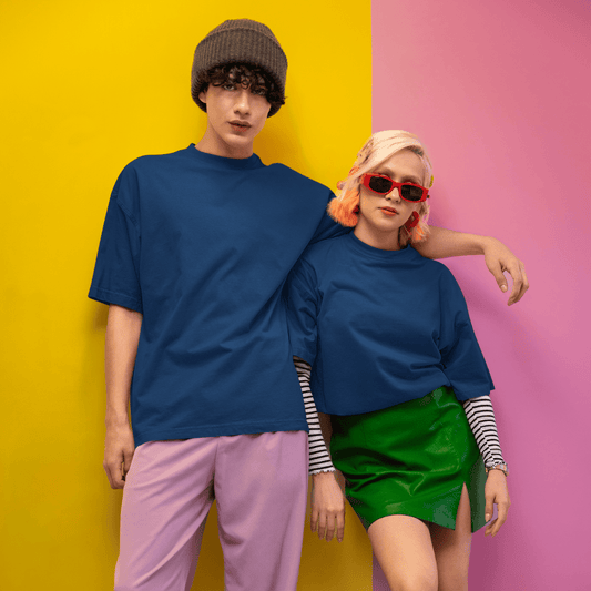 Young man and woman wearing plain navy blue oversized unisex T-shirt by Words Armor