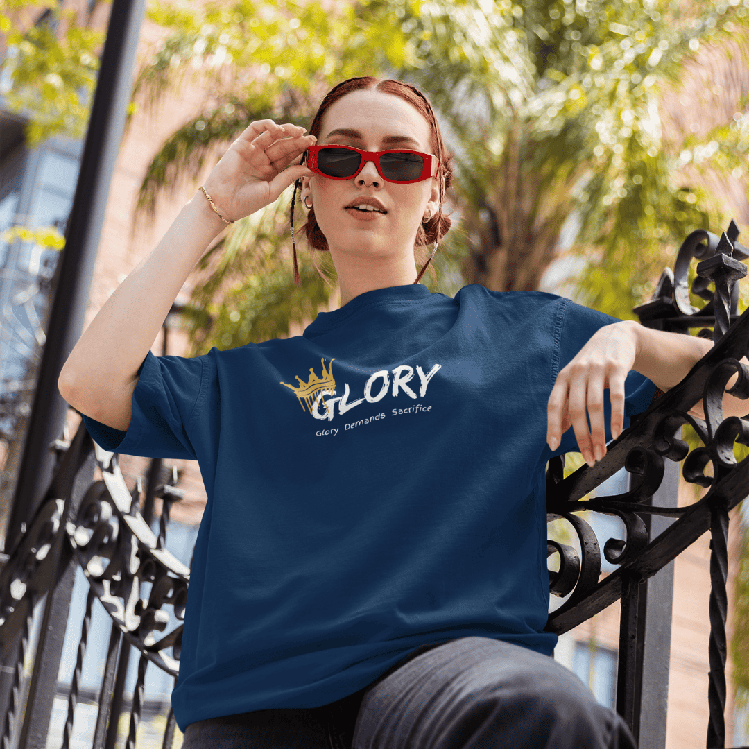 Person wearing a blue t-shirt with 'GLORY' printed on it, sitting outdoors. wordsarmor