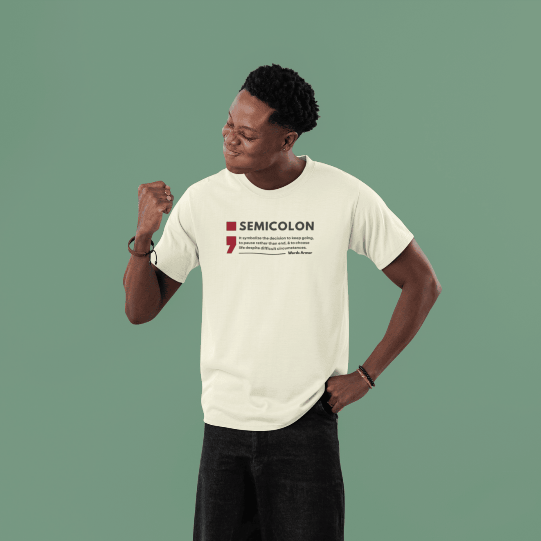 Person wearing a off white t-shirt with 'SEMICOLON' design on a green background wordsarmor
