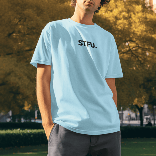 Person wearing a light blue t-shirt with 'STFU.' text outdoors. wordsarmor