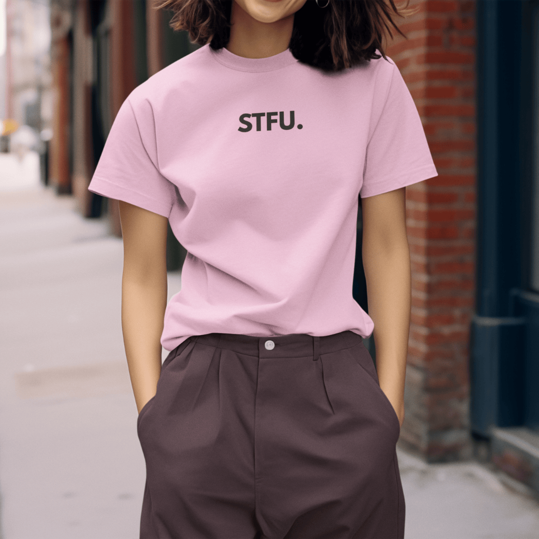 Person wearing a pink t-shirt with 'STFU.' text on a street. wordsarmor