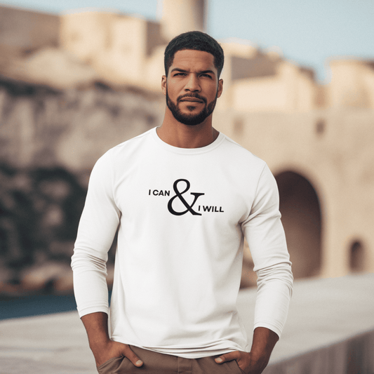 Man wearing a white long-sleeve shirt with 'I can & I will' text, standing in front of a blurred architectural background. wordsarmor