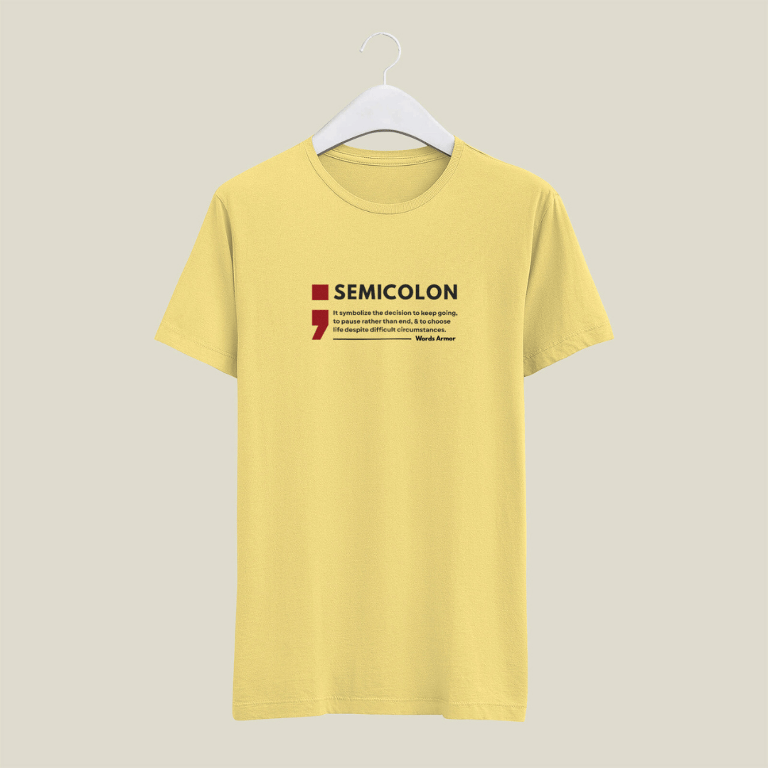 Yellow t-shirt with a semicolon graphic and text on a beige background wordsarmor