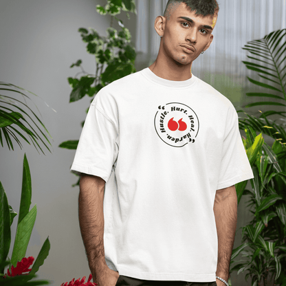 Person wearing a white t-shirt with a logo in a room with plants wordsarmor