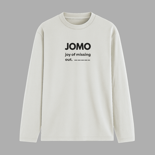 White long-sleeve shirt with 'JOMO joy of missing out' text on a grey background wordsarmor