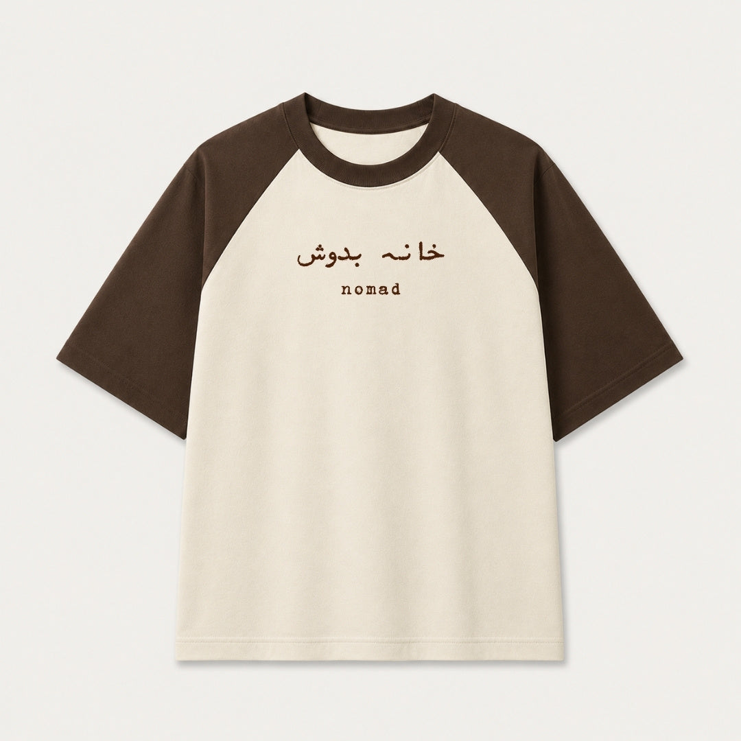 Words Armor Khana Badosh Nomad Urdu oversized raglan t-shirt for men and women in coffee brown and off white featuring Khana Badosh typography on premium 240 GSM cotton.