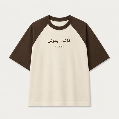 Words Armor Khana Badosh Nomad Urdu oversized raglan t-shirt for men and women in coffee brown and off white featuring Khana Badosh typography on premium 240 GSM cotton.