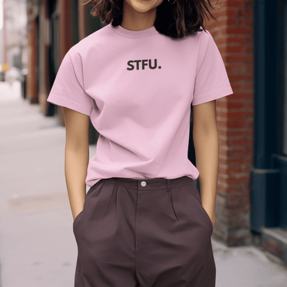 Person wearing a pink t-shirt with 'STFU.' text on a street. wordsarmor